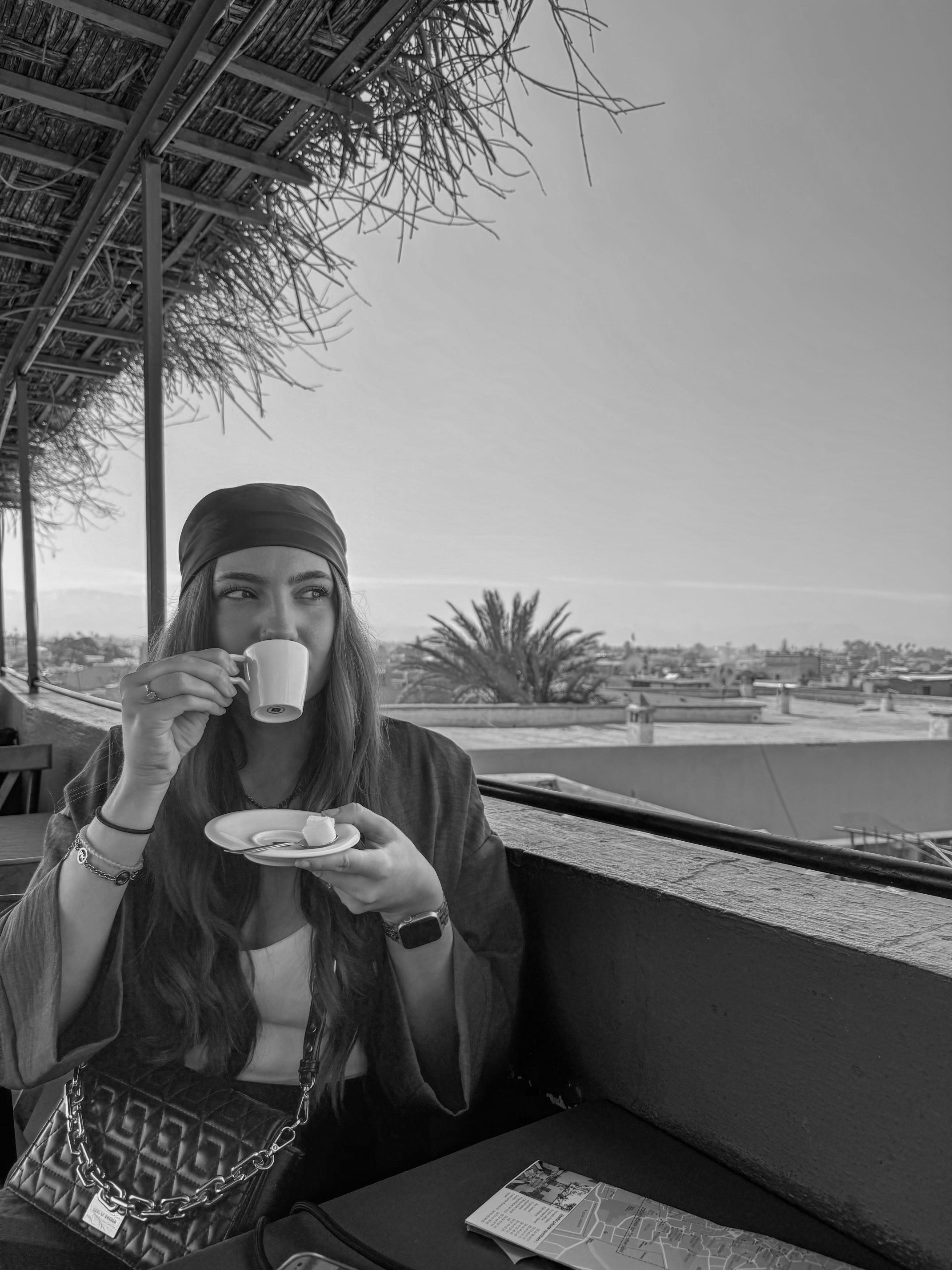 A women drinking a coffee at the rooftop restaurant in the Medina of Marrakech.